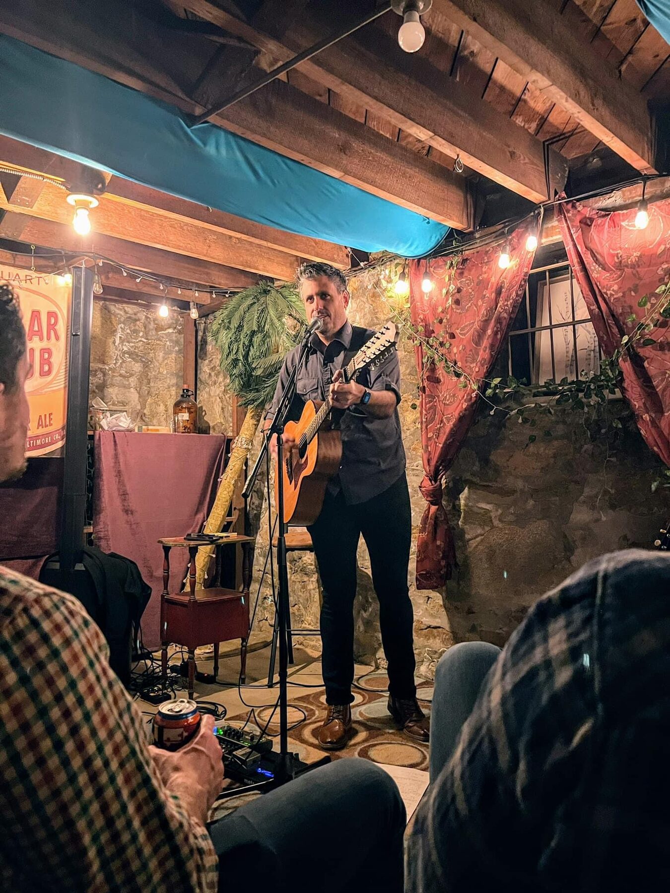 Brody Bond performing at an intimate bar strung with lights