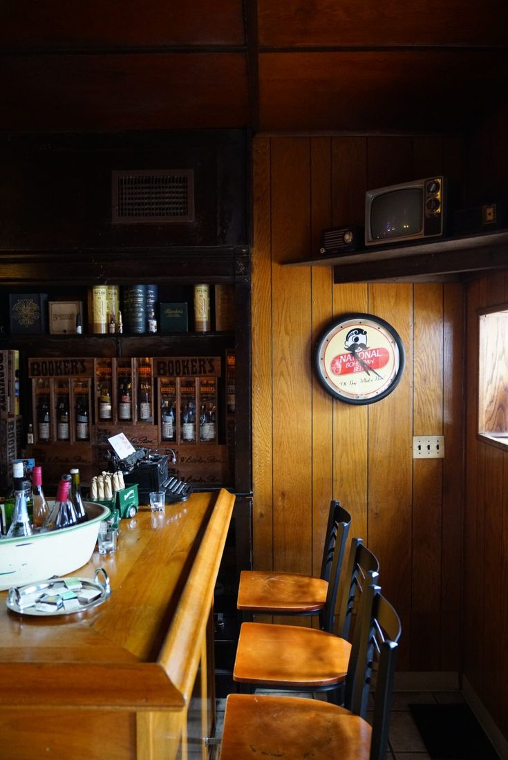 Wooden bar stools beneath a National Bohemian clock
