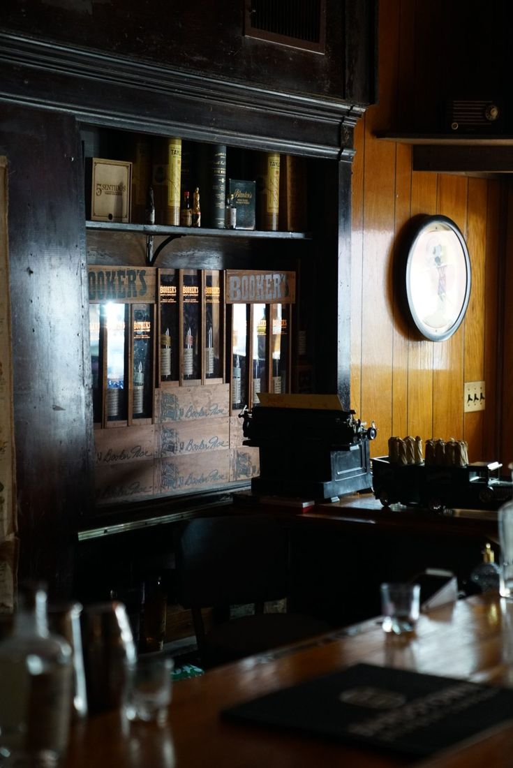 An antique typewriter and Booker's whiskey crates behind the bar